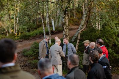 Group of people meeting with trees in the background