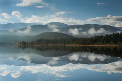 A view across Loch Morlich and Rothiemurchus Forest to the mountains beyond.