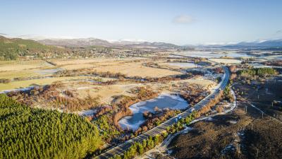 Aerial view of Lochan an Tairbh, near Ruthven, and next to the A9, with Kingussie in the background.