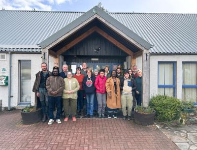 Members of the Cairngorms 2030 Communities Fund panel gather in front of Boat of Garten Community Hall
