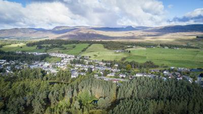 Aerial shot taken from above the Highland Folk Museum, looking towards Newtonmore.