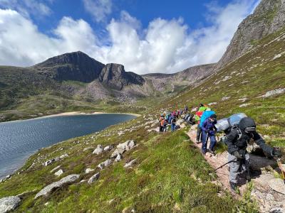 Junior ranger expedition hiking up a mountain path from Loch Avon