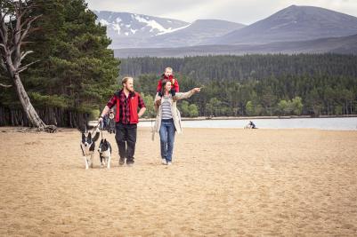 Family with dogs at Loch Morlich beach.
