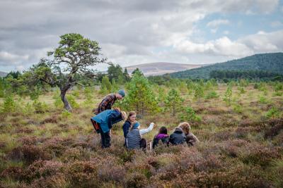 Park Authority Ranger Polly and Cairngorms Connect Community Learning Officer Lotte show pupils from Grantown Grammar how to monitor peatland.