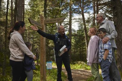 A family talk to a Cairngorms National Park Authority ranger in a woodland area.